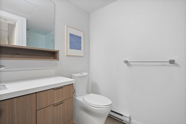 Bathroom with toilet, a baseboard radiator, and vanity | Image 23