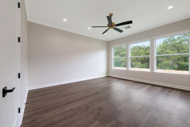 Unfurnished room with crown molding, ceiling fan, dark wood-style flooring, and recessed lighting | Image 39