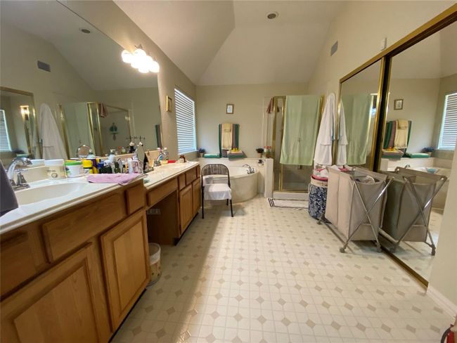 Bathroom with vanity, independent shower and bath, and lofted ceiling | Image 34