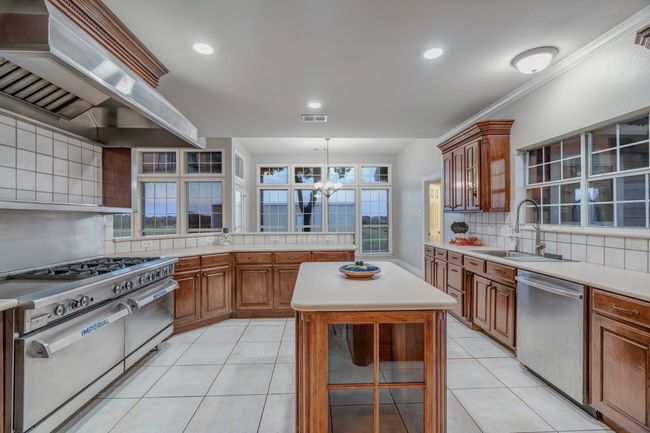 Island provides storage for your favorite cookbooks, spices and overflow kitchen appliances. | Image 21