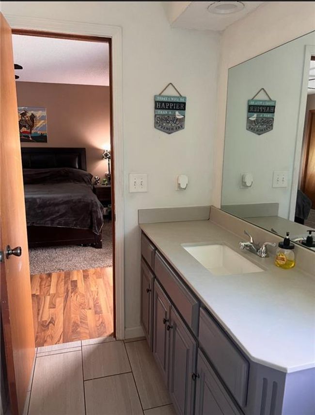 Bathroom with connected bathroom, vanity, and wood finished floors | Image 12