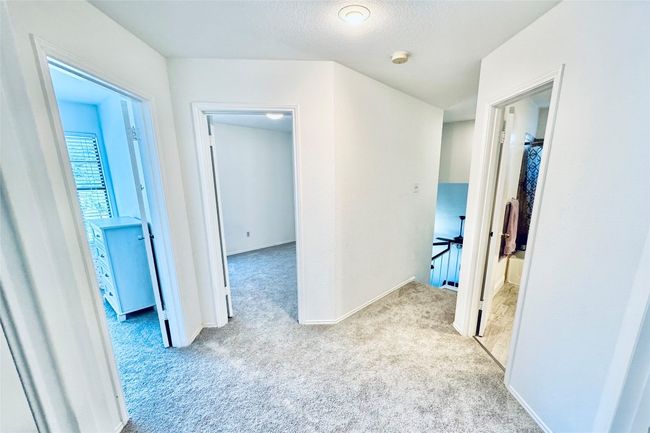 Corridor featuring carpet floors, baseboards, and a textured ceiling | Image 16