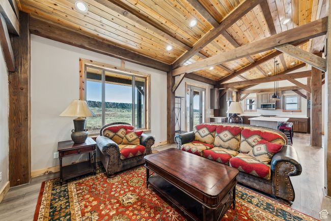 Living room with light wood-type flooring, recessed lighting, baseboards, and wood ceiling | Image 37