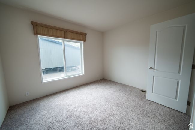 View of carpeted spare room | Image 54