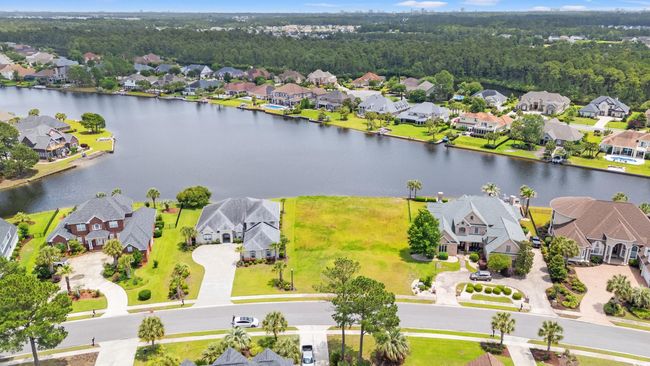 Aerial view of residential area with a large body of water | Image 8