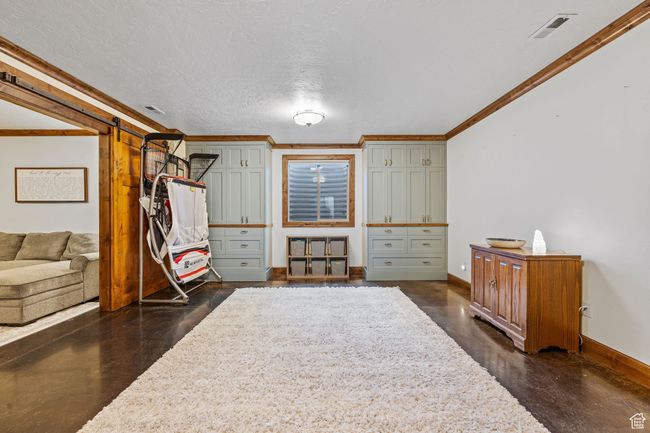 Interior space with crown molding and a textured ceiling | Image 34