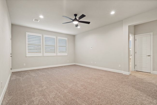 Carpeted empty room featuring ceiling fan and recessed lighting | Image 13