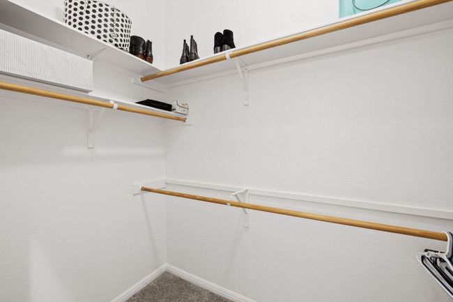 Walk in closet featuring carpet | Image 30