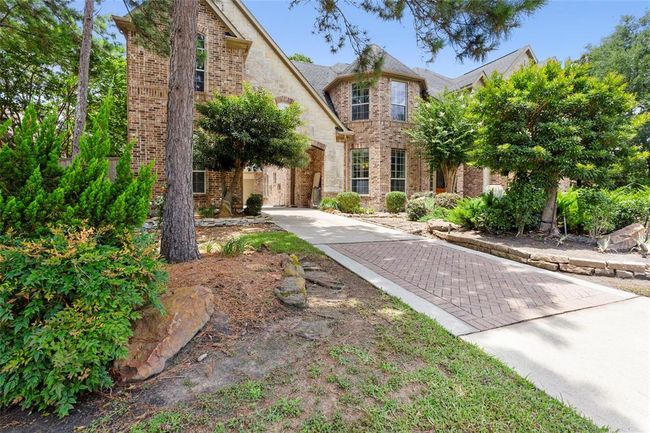 Driveway to porte cochere with one car garage to the left side and two car garage conversion in back. | Image 4