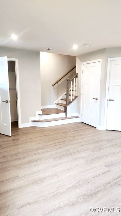 Unfurnished living room with light hardwood / wood-style floors | Image 3