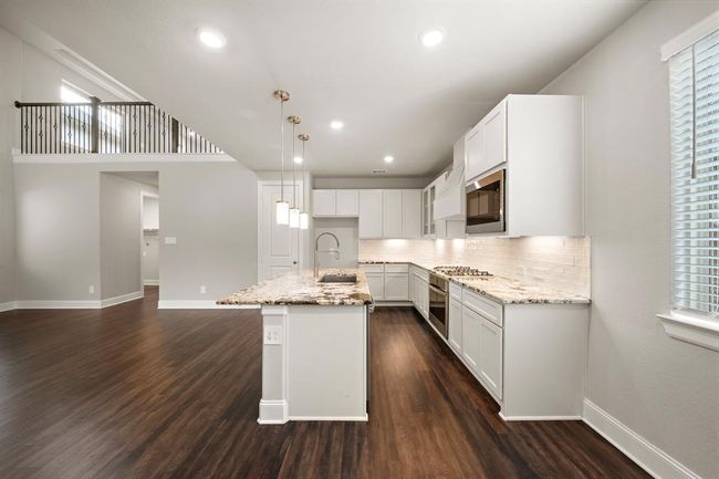 A view of the kitchen from the dining area. | Image 9