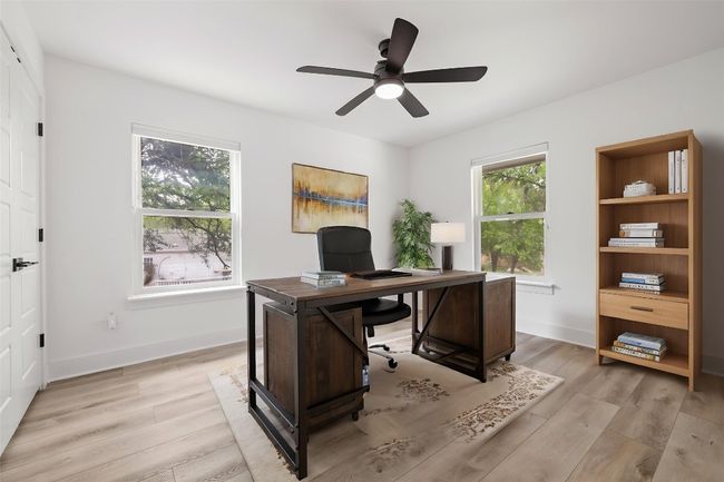 Office with light wood finished floors, baseboards, and ceiling fan | Image 29