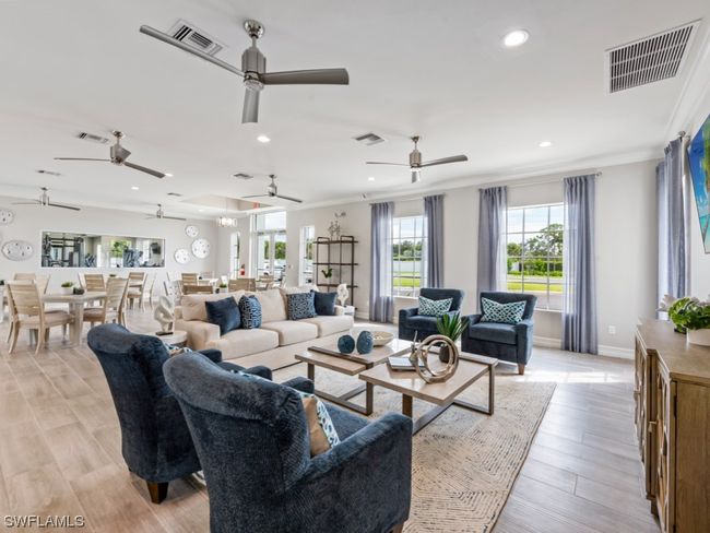 Step into the heart of modern luxury at the community clubhouse's newly built social room. Chic design welcomes you to relax in a stylish sitting area, where comfort and sophistication seamlessly unite | Image 29