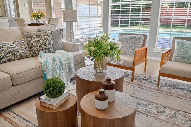 This charming home features a classic brick exterior, a well-maintained front yard with mature landscaping, and large windows providing ample natural light. The inviting driveway leads to a spacious garage, and the overall setting offers a pleasant and welcoming curb appeal. | Image 7