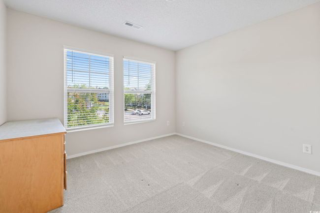 Unfurnished room with plenty of natural light, light colored carpet, baseboards, and a textured ceiling | Image 20
