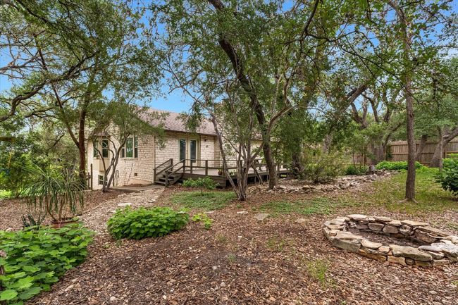 Backyard view of home and natural landscaping | Image 16