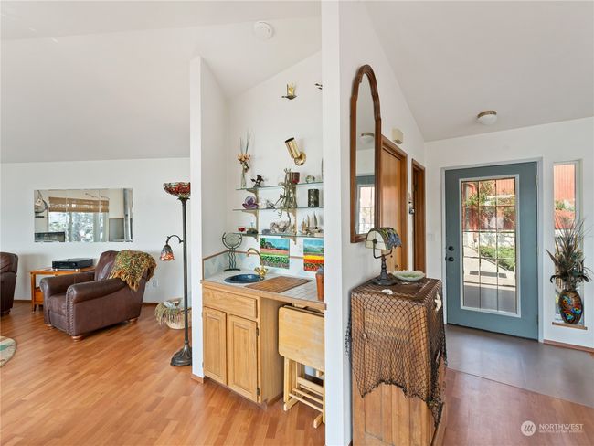 To right of entry, a wet bar and the living area. | Image 8