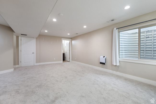 Empty room with recessed lighting, light carpet, and a smoke detector | Image 25