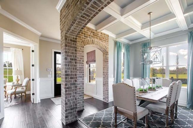 Upon entering you are greeted with a brick accent wall in the dining room. | Image 7