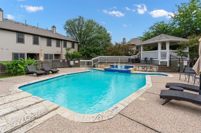 Community pool featuring a jacuzzi, a gazebo, and a patio area | Image 23