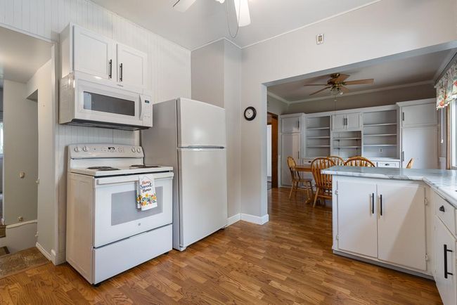 Kitchen opens up to the dining room for easy meal preparation and serving | Image 15