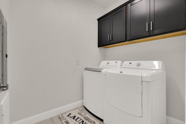 Laundry Room featuring cabinet space, independent washer and dryer, and baseboards | Image 26