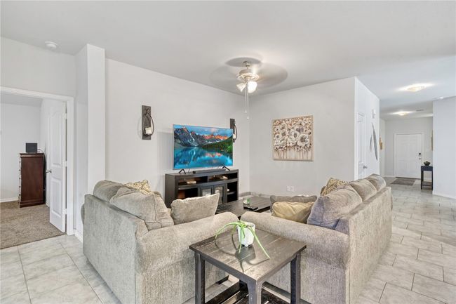 Living room with ceiling fan | Image 10