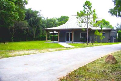 View from backyard showing standing seam tin roof | Image 1