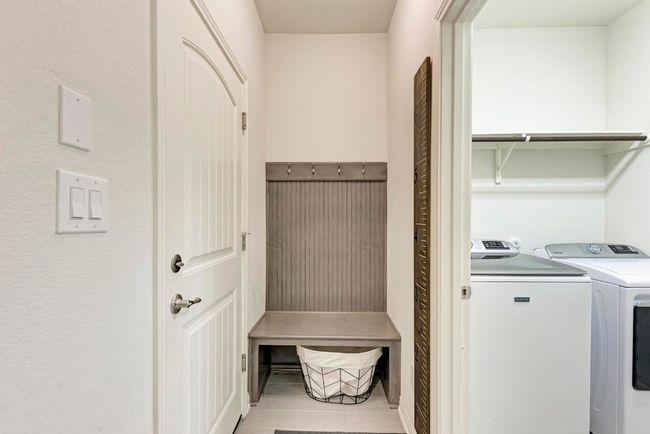 The area adjacent to the garage offers a niche for coats, shoes, scarves, and hats storage. The indoor utility room is to the Right of the photo. | Image 36