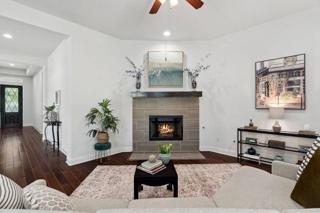 The living room hosts a gas fireplace with a gorgeous quartz surround. | Image 8