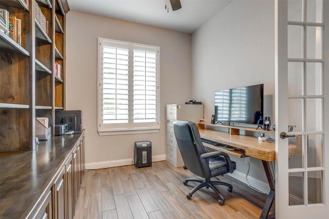 Office space with light wood-style floors and ceiling fan | Image 34