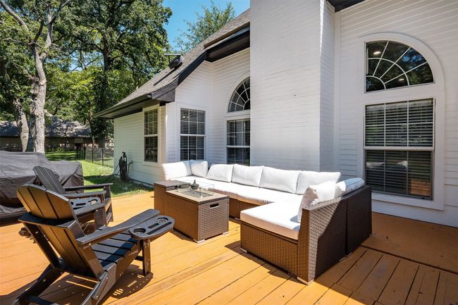 Wooden terrace featuring an outdoor living space with a fire pit | Image 15