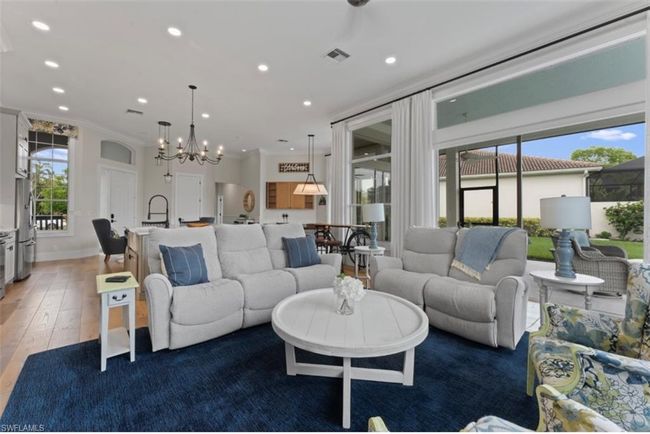 Living room with light wood-style floors, recessed lighting, a chandelier, and ornamental molding | Image 10