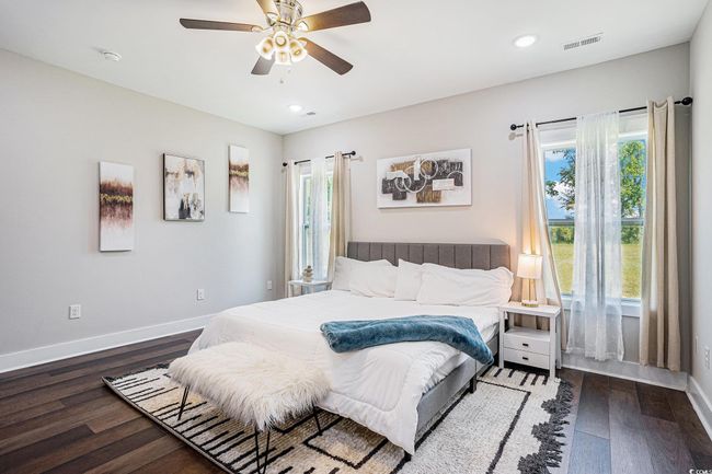 Bedroom featuring multiple windows, wood finished floors, recessed lighting, and a ceiling fan | Image 10