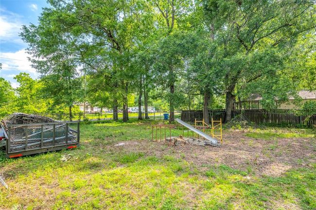 Expansive second lot with mature trees, offering endless possibilities for development or personal retreat. | Image 10