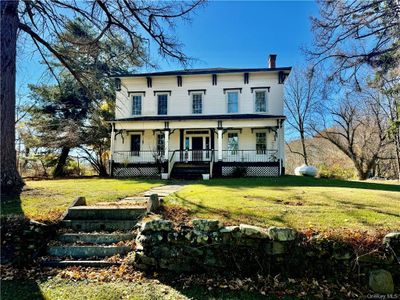 Italianate house featuring a porch and a front lawn | Image 2