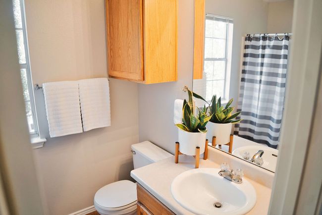 Bathroom with vanity and curtained shower | Image 27