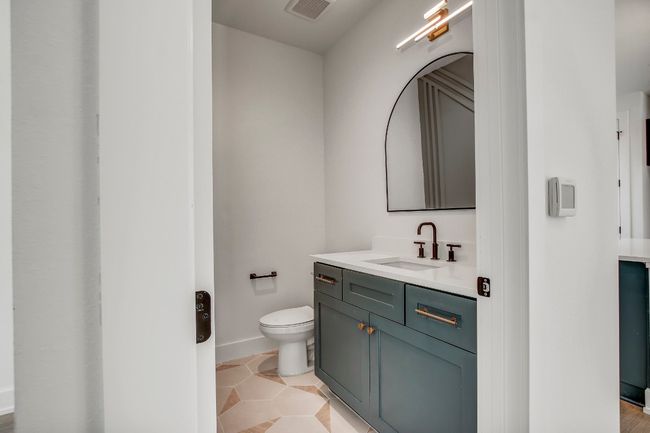 Bathroom with vanity, toilet, baseboards, and tile patterned flooring | Image 11