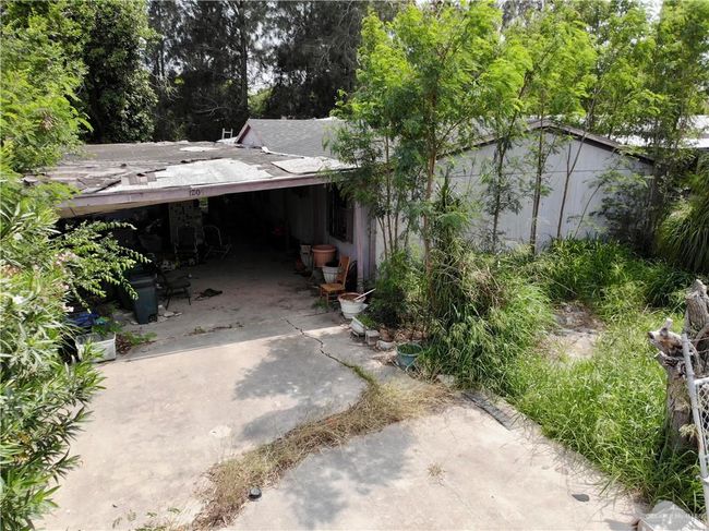 View of property exterior with concrete driveway | Image 11