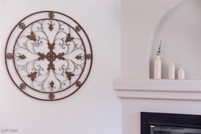 Room details with a gate and a glass covered fireplace | Image 6