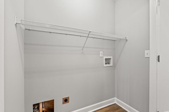 Laundry area with electric dryer hookup, washer hookup, and wood finished floors | Image 24