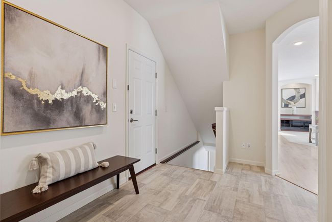 Mud Room leads to Guest Bath, stairs to lower level and kitchen pantry access | Image 19