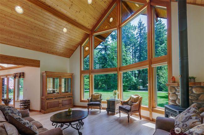 Vaulted ceilings and a wall of windows in the family room. Propane fireplace for those cold nights. | Image 4