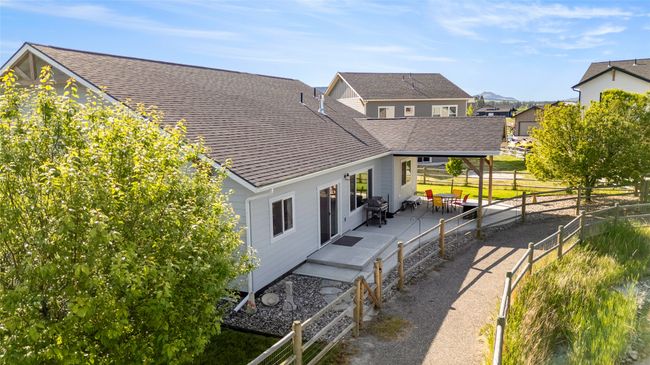 Rear view of house with a patio, roof with shingles, and a residential view | Image 33