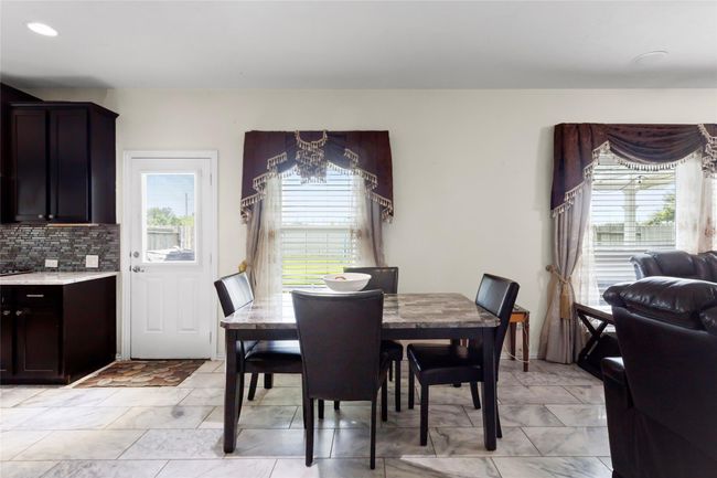 Bright dining area with large windows | Image 12