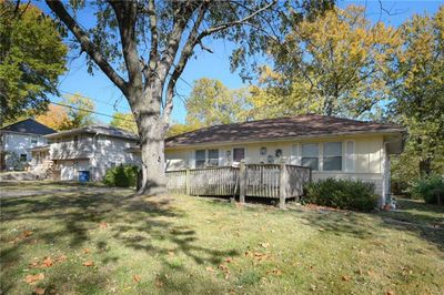 View of front facade with a front yard and a wooden deck | Image 1