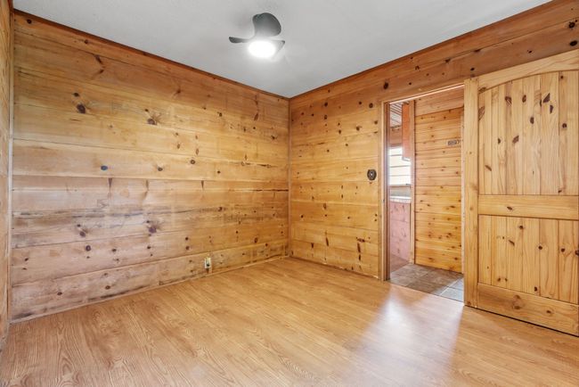 Unfurnished room featuring wood finished floors and wood walls | Image 23