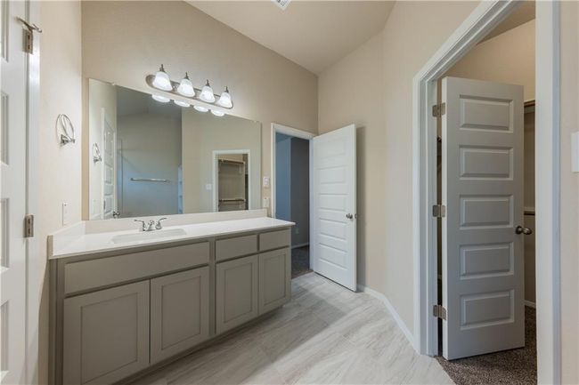 Bathroom featuring vanity and baseboards | Image 12