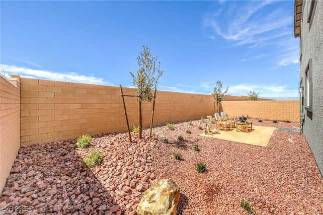 Photo is representational only; actual home finishes may vary. Fenced backyard with a patio area | Image 42