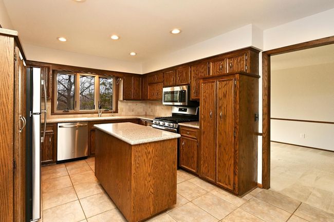 Freshly Painted Large Updated Kitchen Features Center Island, Loads of Storage with Screen Porch through Sliders. All Appliances Stay! | Image 24